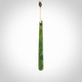 This picture shows a hand carved jade drop pendant by Ric Moor. The jade is a wonderful light, semi-translucent, green. It is suspended from a meringue coloured adjustable cord. Delivery is free worldwide.